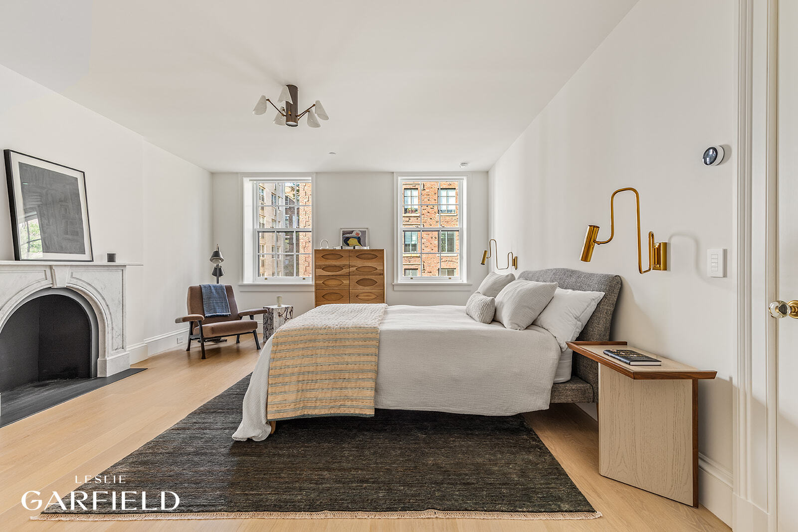 60 West 9th Street Manhattan, NY 10011 - Photo 19 of 22 a bedroom with a large bed and a couch