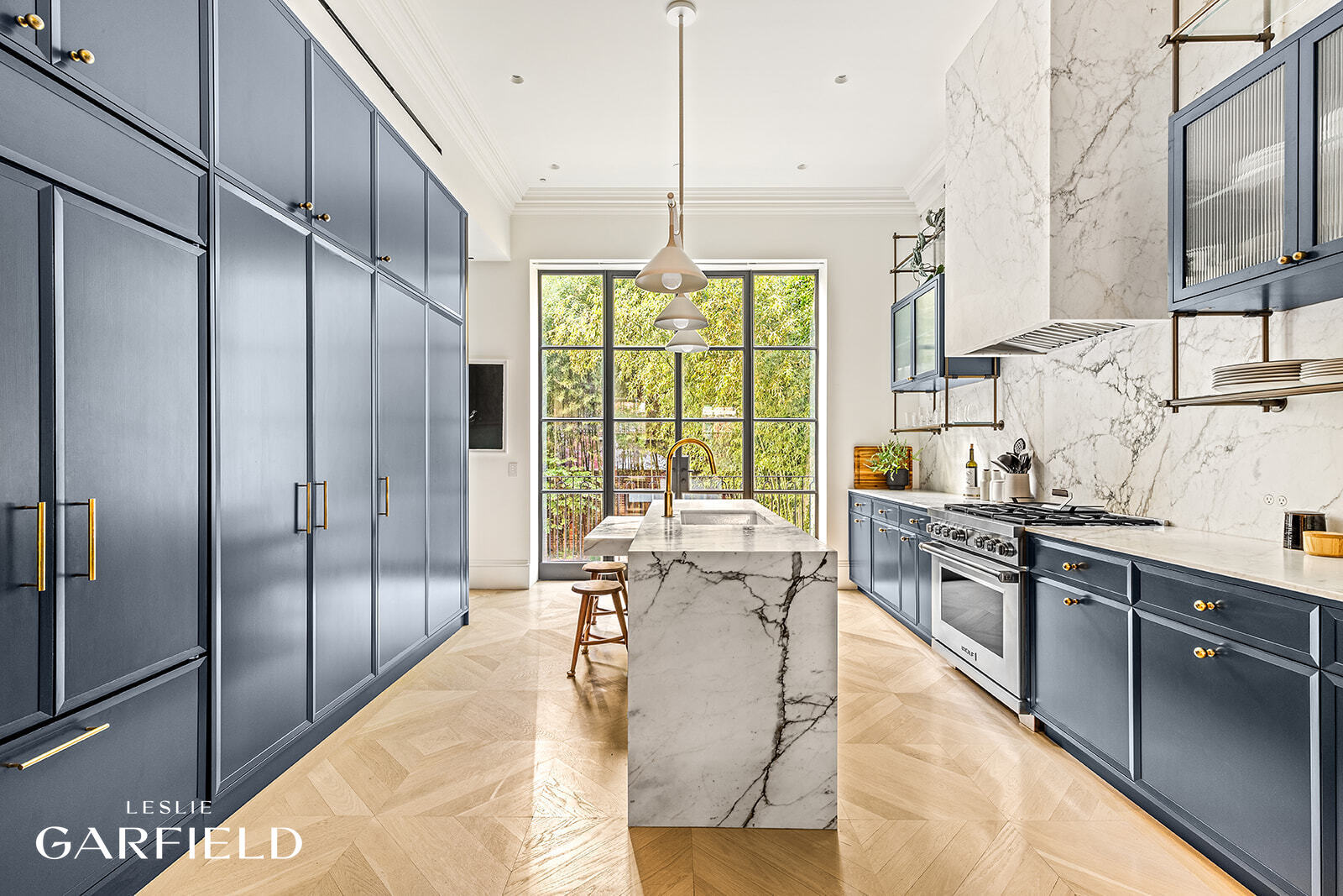 60 West 9th Street Manhattan, NY 10011 - Photo 4 of 22 a kitchen with stainless steel appliances granite countertop a sink a stove and refrigerator