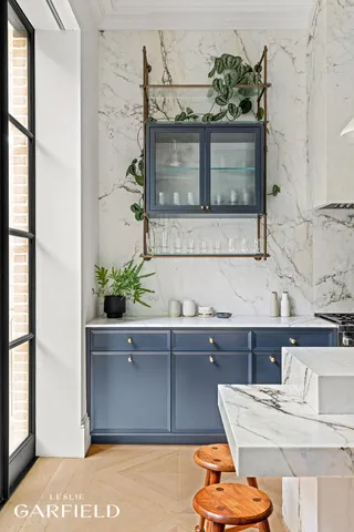 a kitchen with stainless steel appliances granite countertop a sink a stove and refrigerator