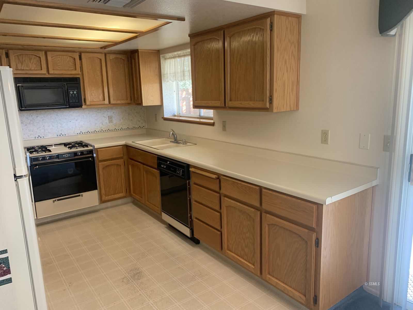 328 Ashton Street Ridgecrest, CA 93555 - Photo 3 of 28 a kitchen with stainless steel appliances granite countertop a sink stove and microwave