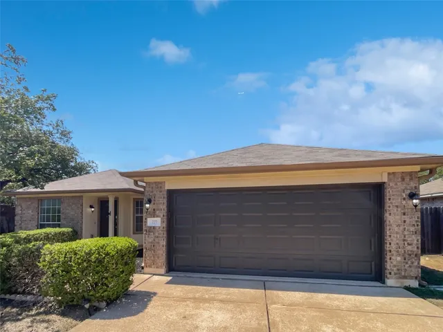 a front view of a house with a garage
