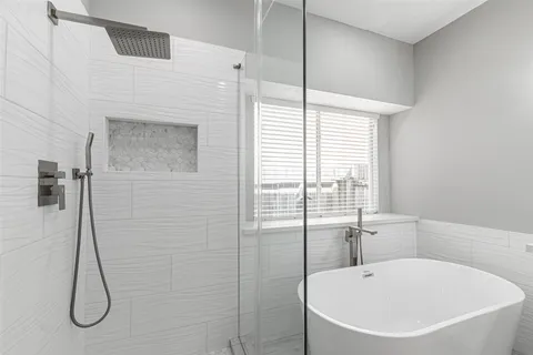a bathroom with a tub and a shower