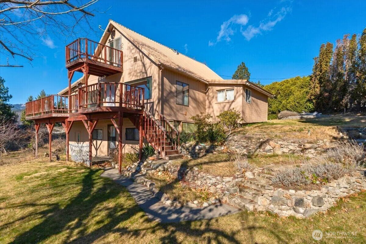 475 Totem Pole Road Manson, WA 98831 - Photo 30 of 33 a view of a house with a yard