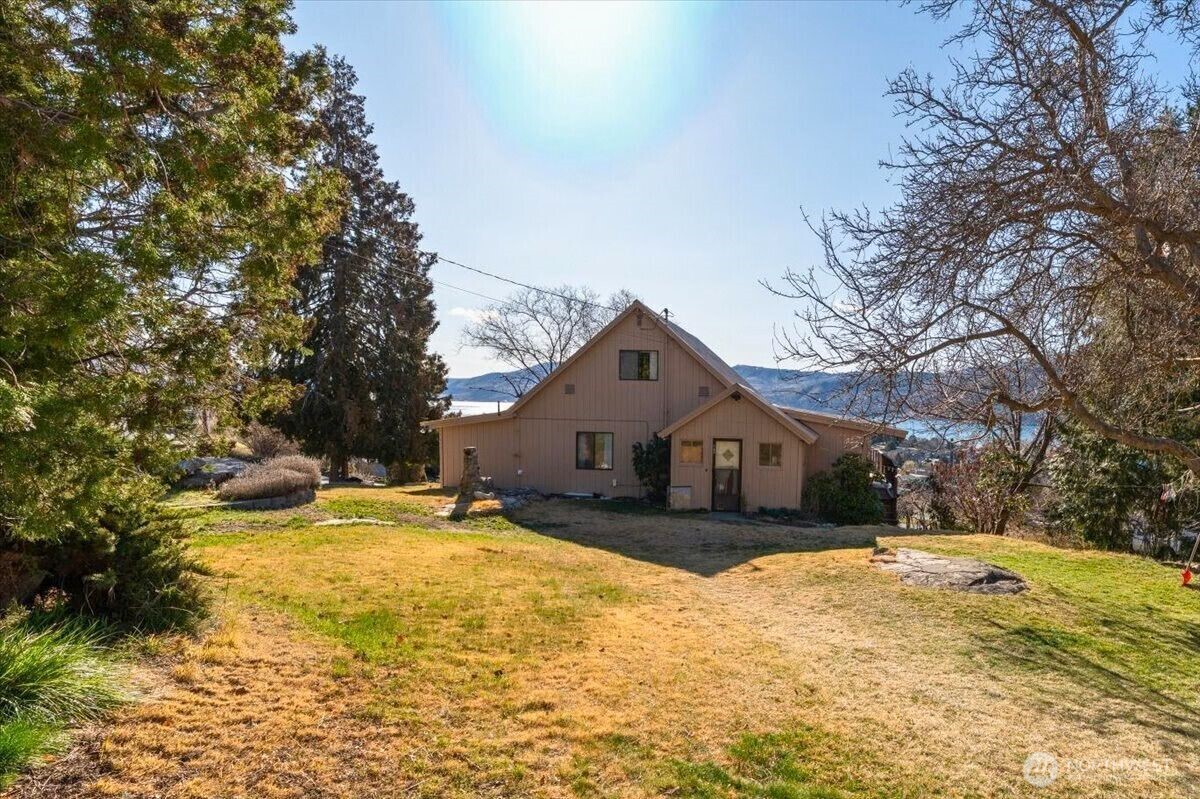 475 Totem Pole Road Manson, WA 98831 - Photo 32 of 33 a front view of a house with a yard covered with snow and trees