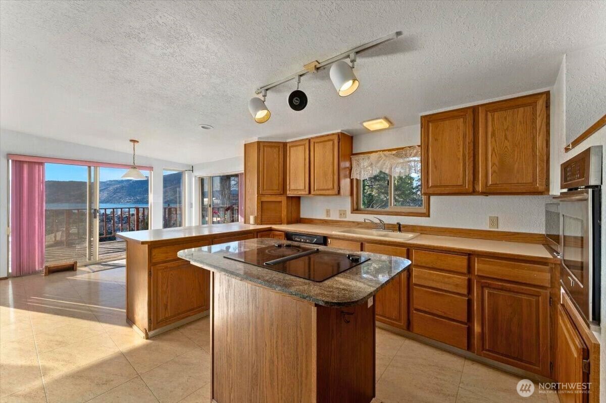475 Totem Pole Road Manson, WA 98831 - Photo 5 of 33 a kitchen with stainless steel appliances granite countertop a sink and a refrigerator