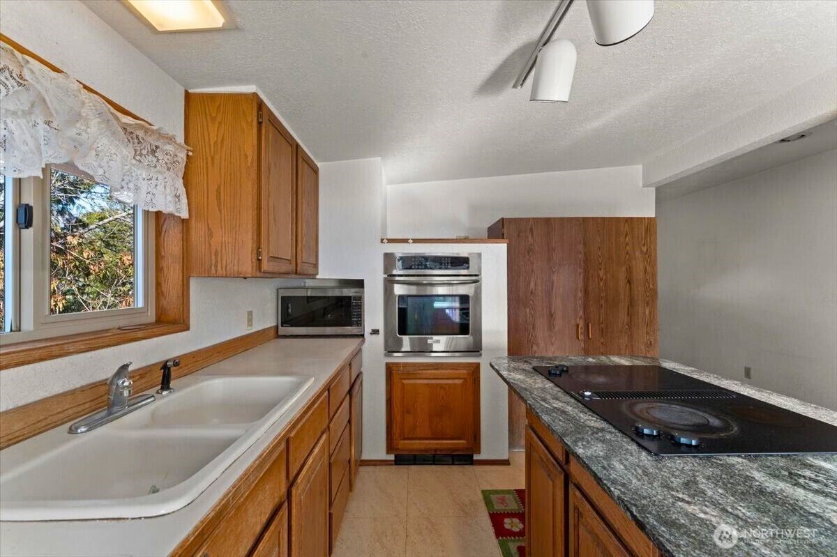 475 Totem Pole Road Manson, WA 98831 - Photo 8 of 33 a kitchen with stainless steel appliances granite countertop a sink stove and refrigerator