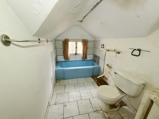 a bathroom with a toilet a sink and shower