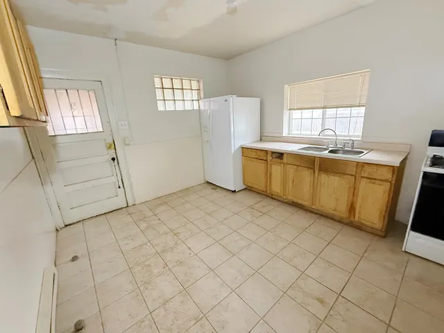 a room with a window and a kitchen view
