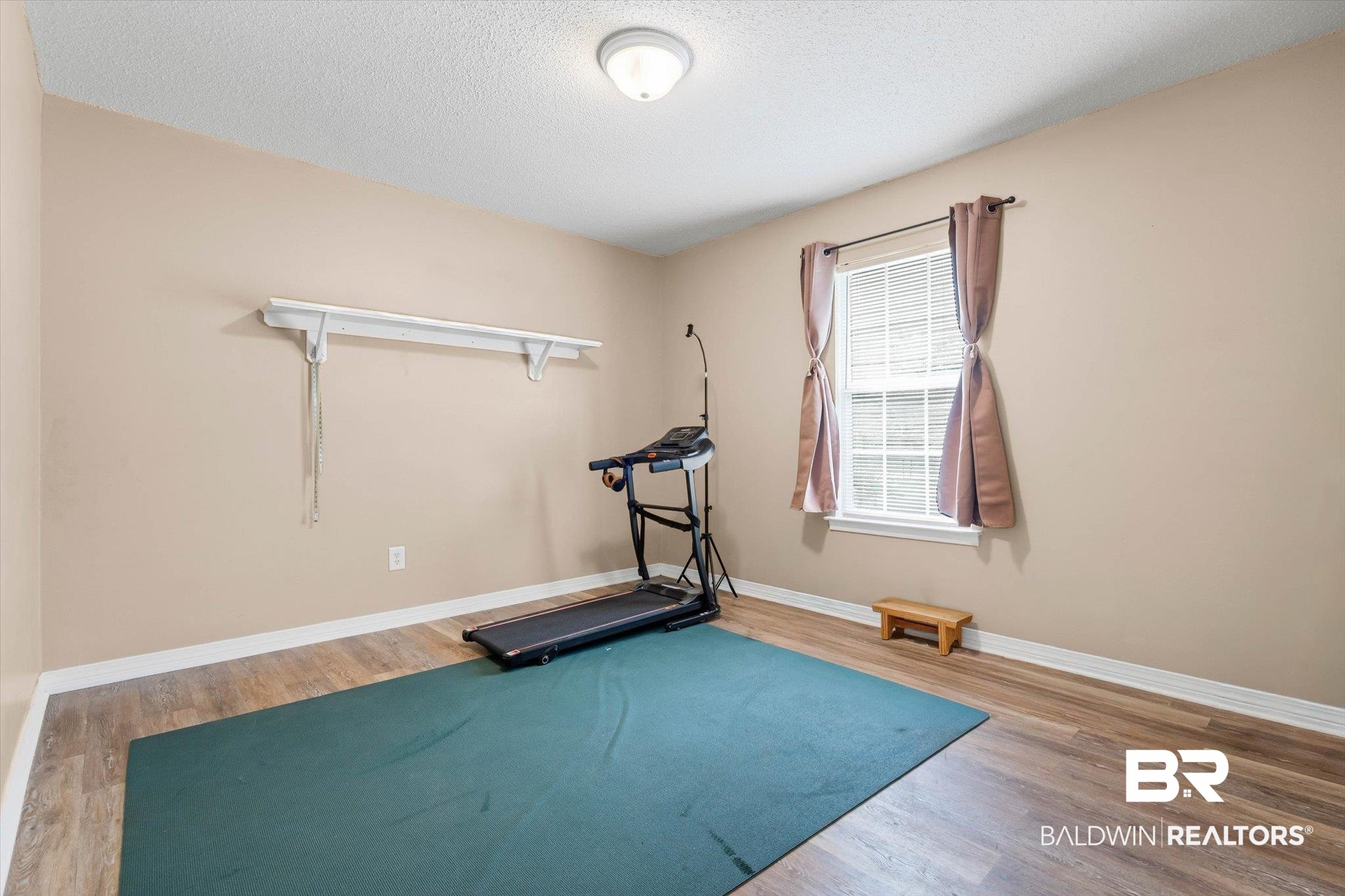 14165 River Oaks Road, Unit A & B Coden, AL 36523 - Photo 9 of 35 Exercise area with light wood finished floors and a textured ceiling