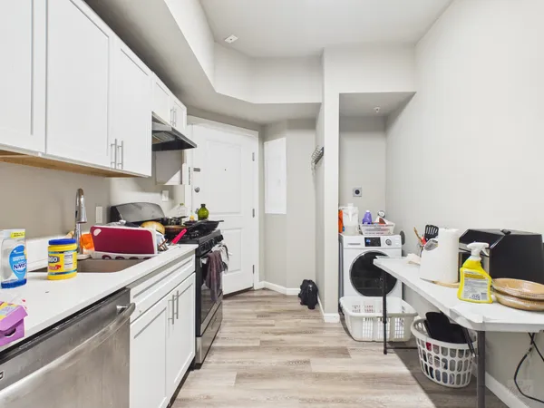 a kitchen that has a lot of cabinets and appliances