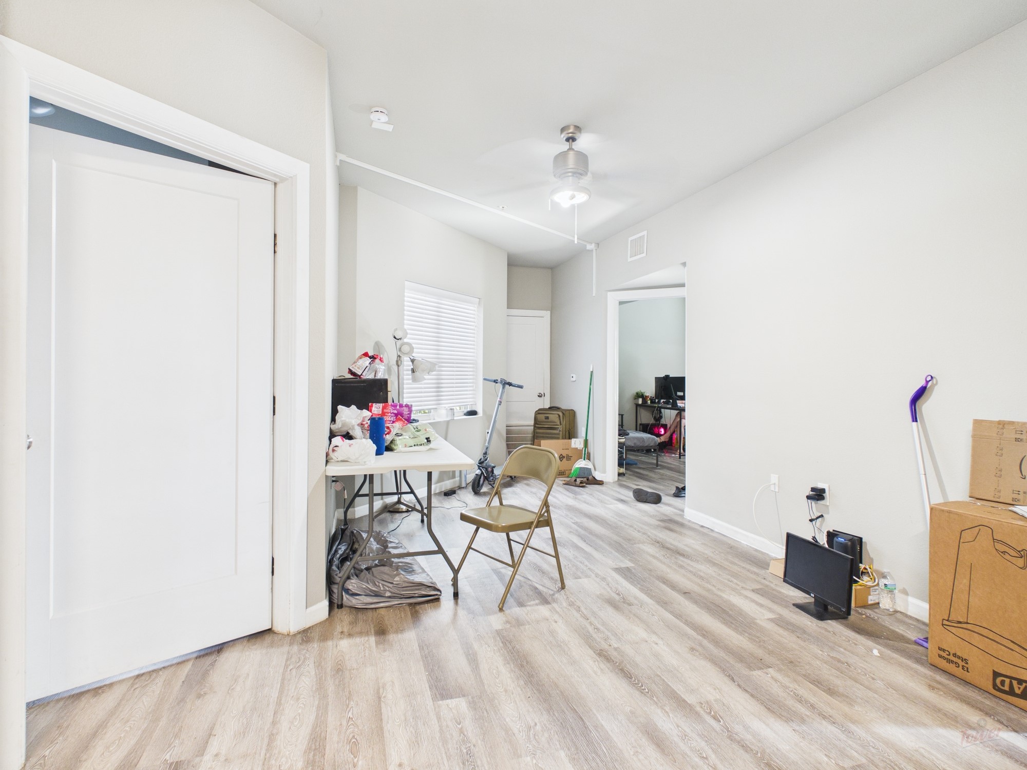 911 West 22nd Street, Unit 404 Austin, TX 78705 - Photo 4 of 13 a living room with furniture and a wooden floor
