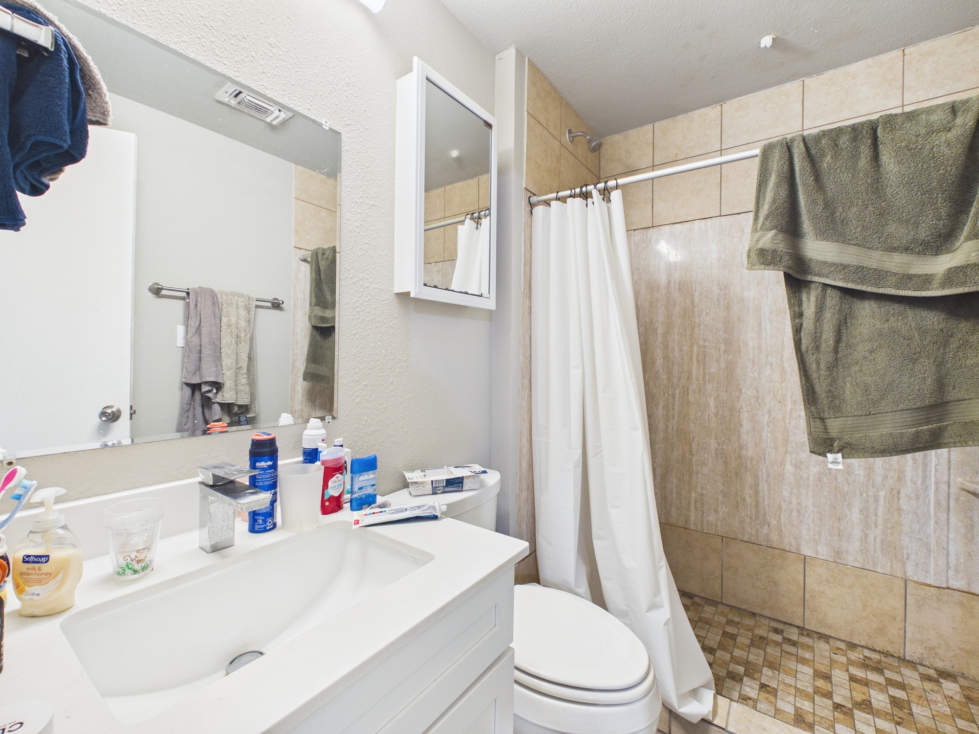 911 West 22nd Street, Unit 404 Austin, TX 78705 - Photo 6 of 13 a bathroom with a sink toilet and shower
