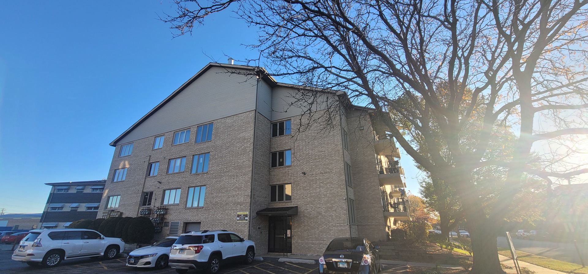 4530 West 93rd Street, Unit 2B Oak Lawn, IL 60453 - Photo 1 of 22 a front view of a building with parking area