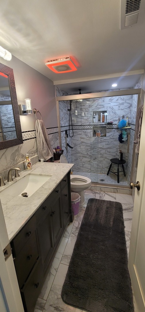 4530 West 93rd Street, Unit 2B Oak Lawn, IL 60453 - Photo 17 of 22 a bathroom with a double vanity sink and a mirror