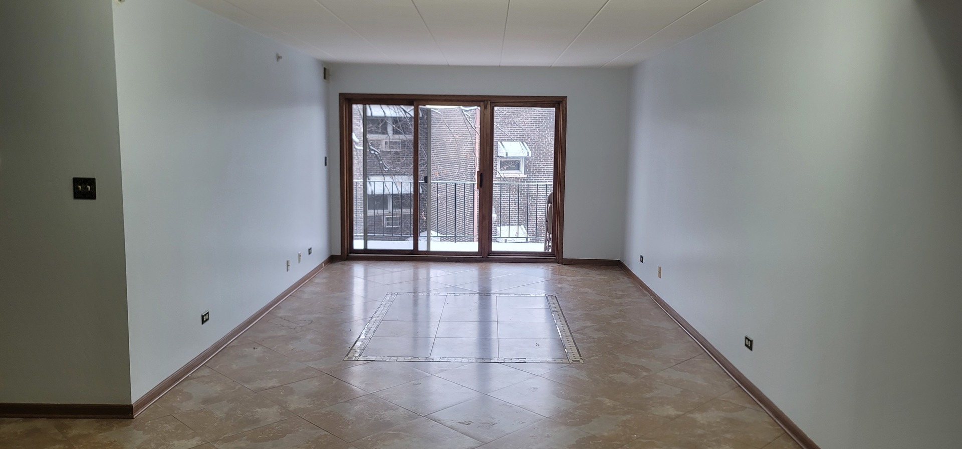 4530 West 93rd Street, Unit 2B Oak Lawn, IL 60453 - Photo 6 of 22 an empty room with wooden floor and windows