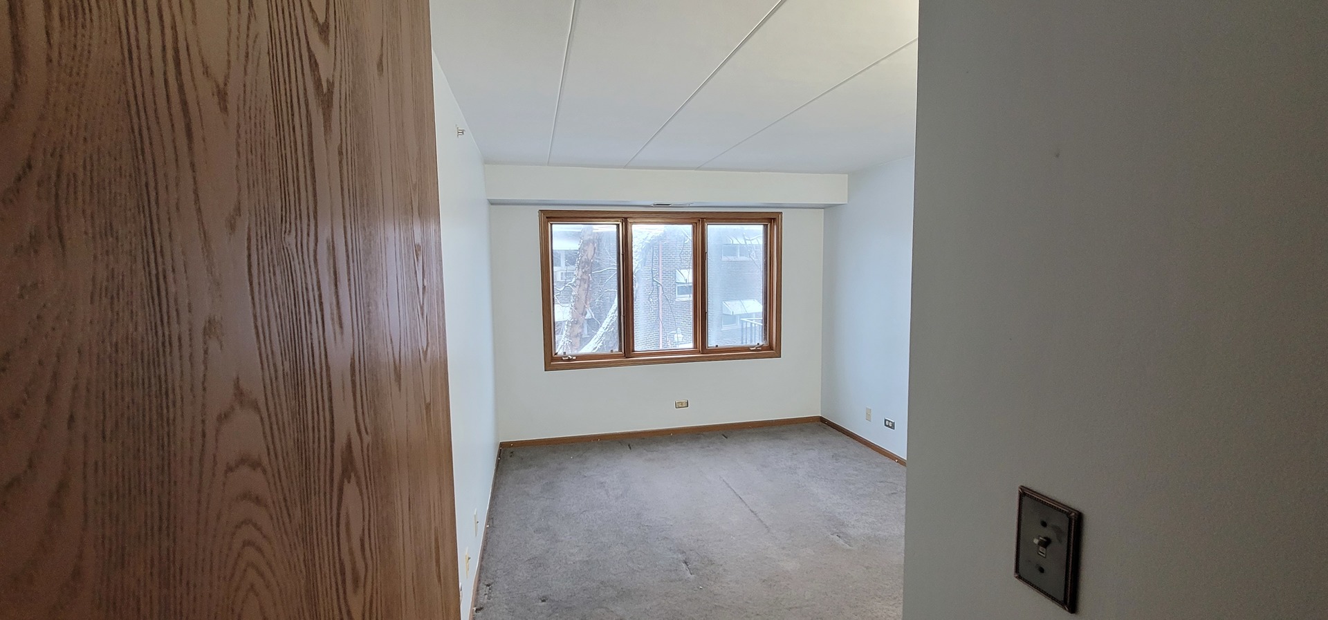 4530 West 93rd Street, Unit 2B Oak Lawn, IL 60453 - Photo 9 of 22 a view of an empty room with a window