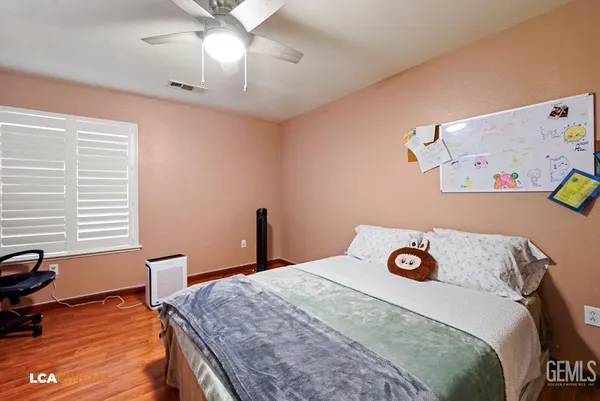 a bedroom with a bed and a desk