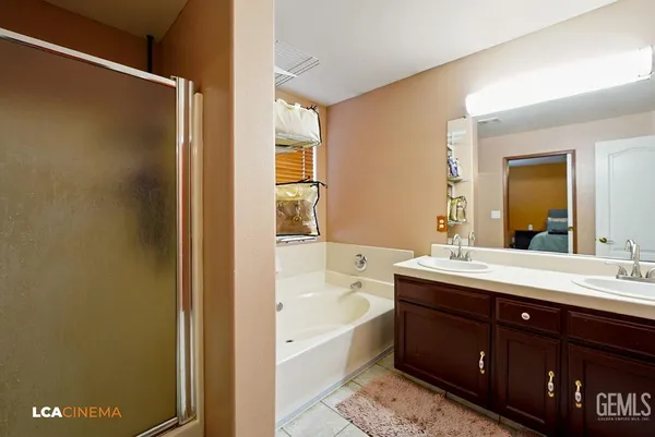 a bathroom with a tub sink and mirror