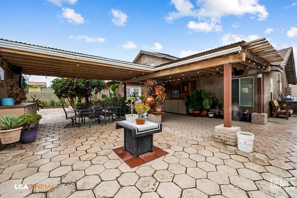 a view of living room with patio furniture and potted plants