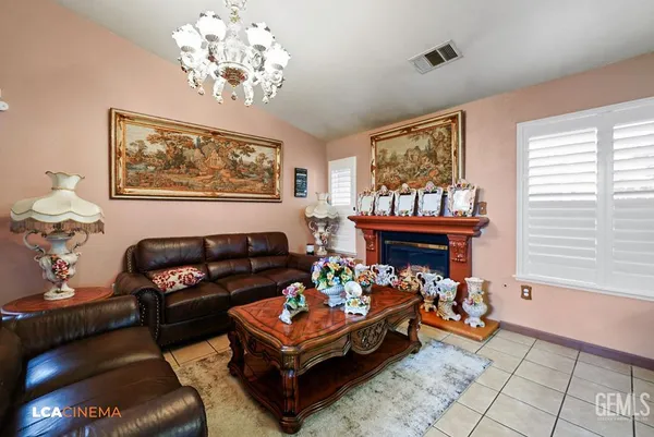 a living room with furniture a chandelier and a window