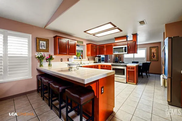 a kitchen with granite countertop a sink and a stove top oven