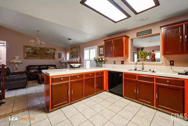 a large kitchen with stainless steel appliances granite countertop a sink and cabinets