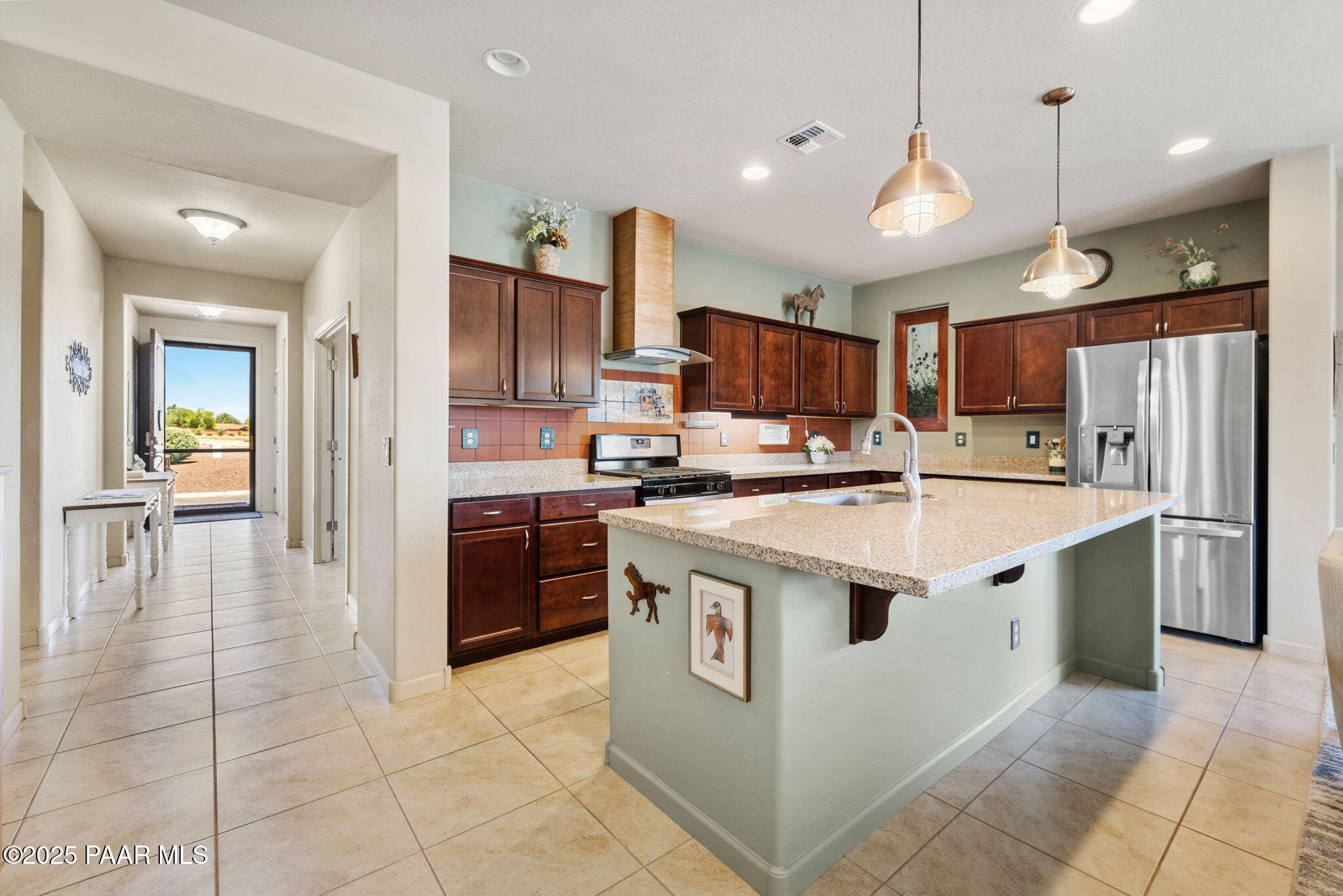 7794 Lavender Loop Prescott Valley, AZ 86315 - Photo 12 of 57 a kitchen with kitchen island a sink a counter top space stainless steel appliances and cabinets