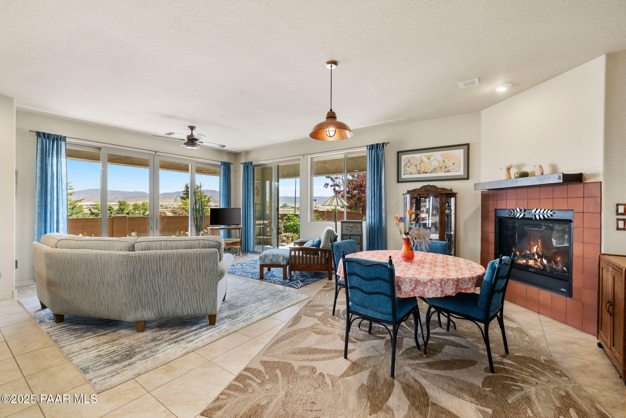 7794 Lavender Loop Prescott Valley, AZ 86315 - Photo 14 of 57 a living room with furniture a fireplace and a dining table with wooden floor