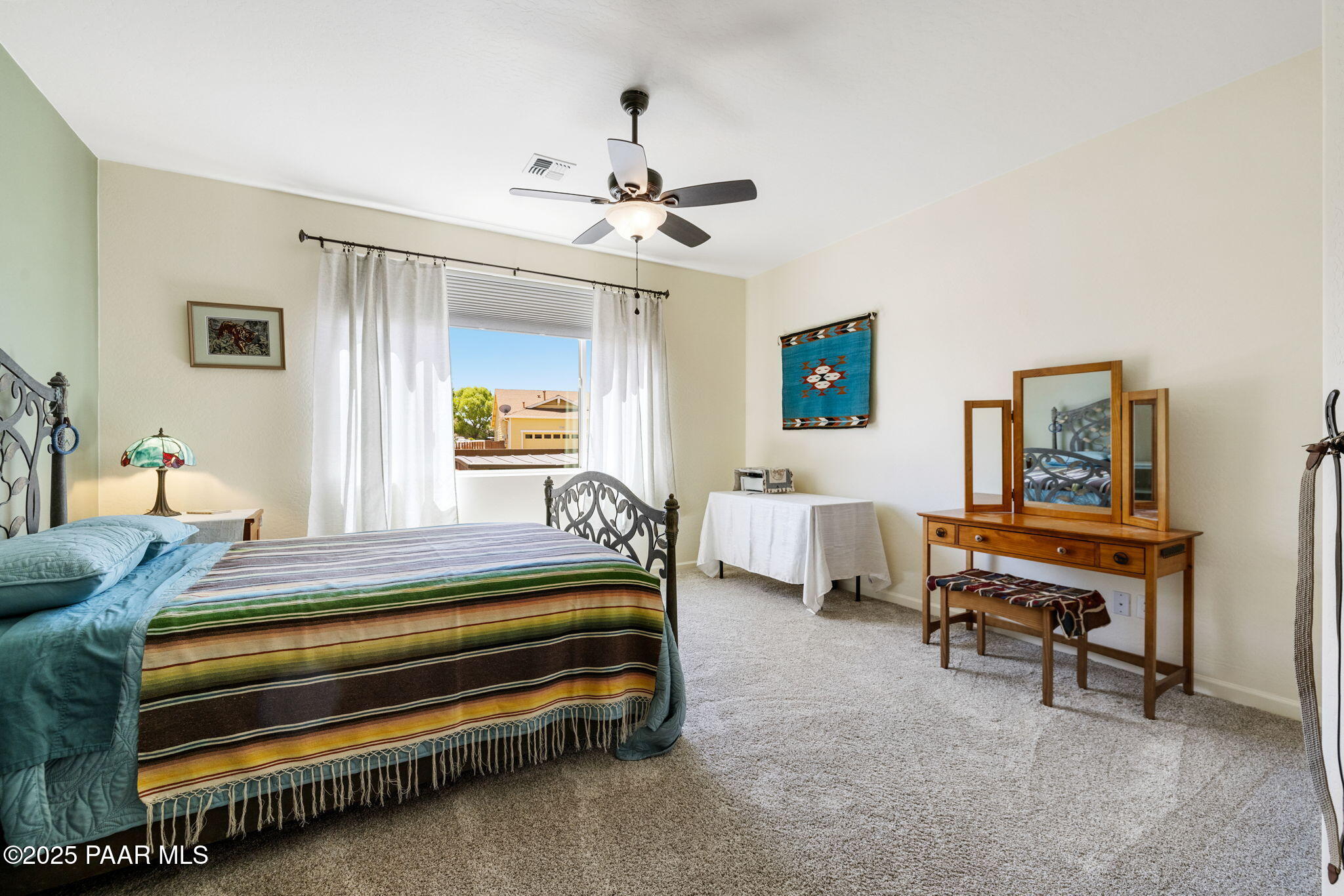 7794 Lavender Loop Prescott Valley, AZ 86315 - Photo 15 of 57 a bedroom with a bed and a chandelier