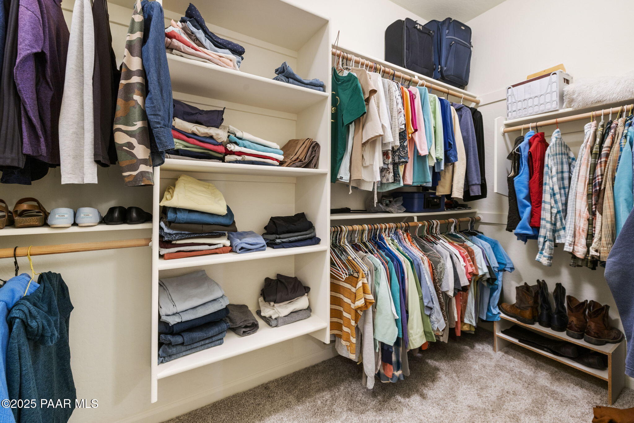 7794 Lavender Loop Prescott Valley, AZ 86315 - Photo 19 of 57 a view of walk in closet with clothes and shoes