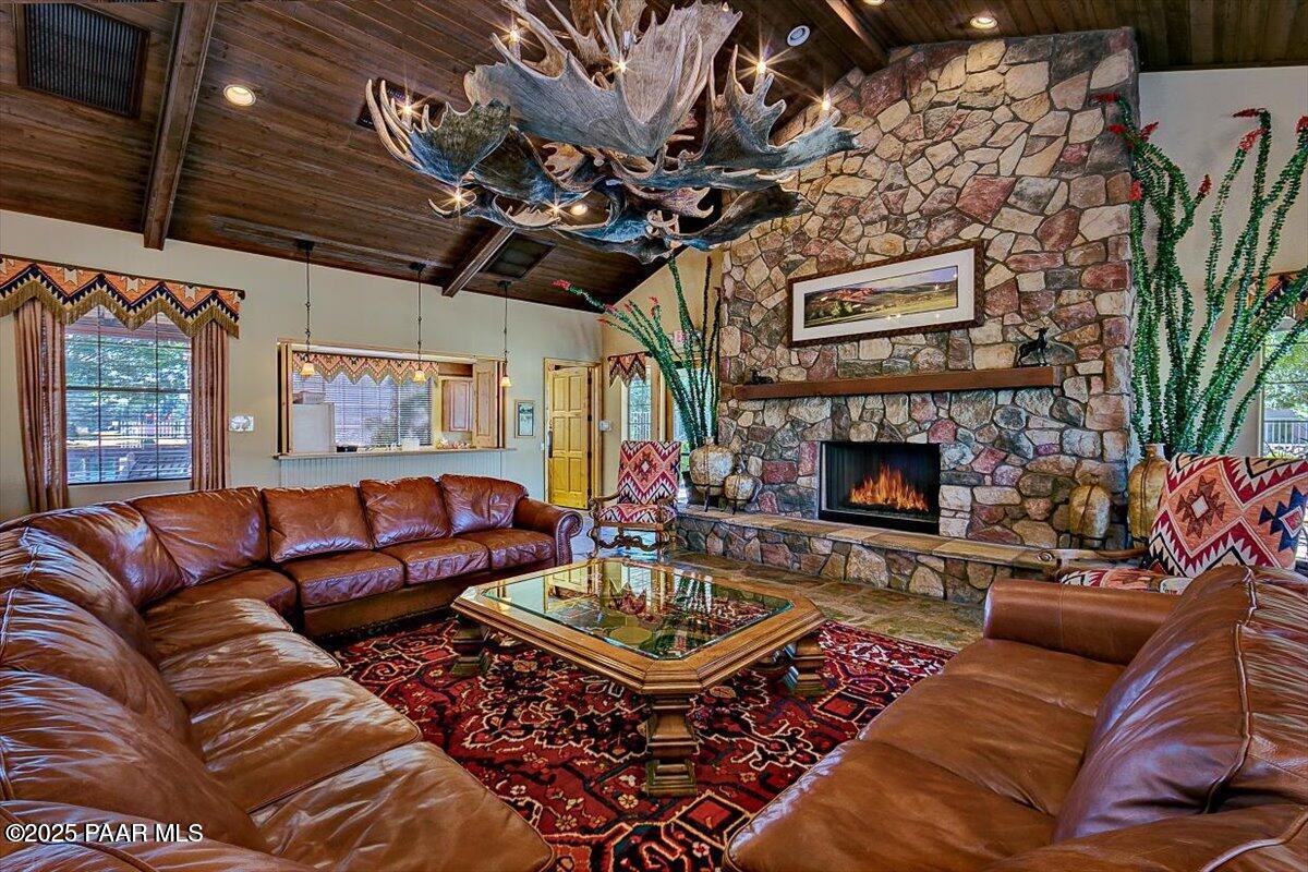 7794 Lavender Loop Prescott Valley, AZ 86315 - Photo 46 of 57 a living room with furniture a flat screen tv and a fireplace