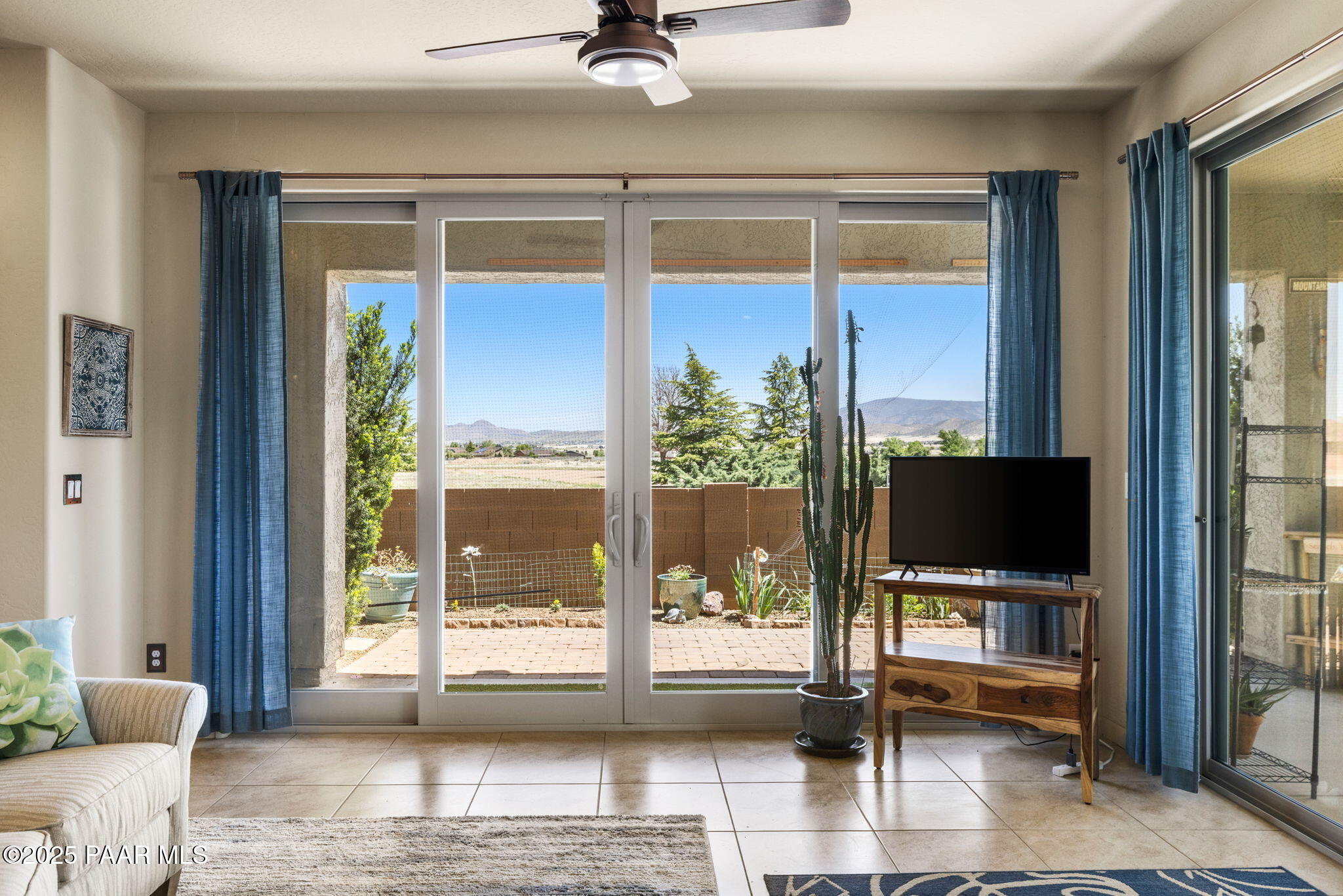7794 Lavender Loop Prescott Valley, AZ 86315 - Photo 9 of 57 a living room with a flat screen tv and a floor to ceiling window
