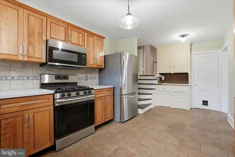 a kitchen with stainless steel appliances granite countertop a refrigerator stove a sink and dishwasher