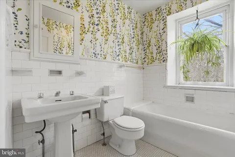 a bathroom with a sink a toilet and a bathtub