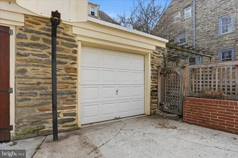 a view of a house with a wooden fence