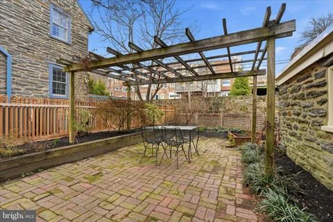 a view of a porch with a table and chairs