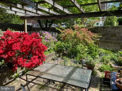 a front view of a house with a yard and fountain