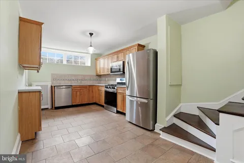 a kitchen with stainless steel appliances a refrigerator and a sink