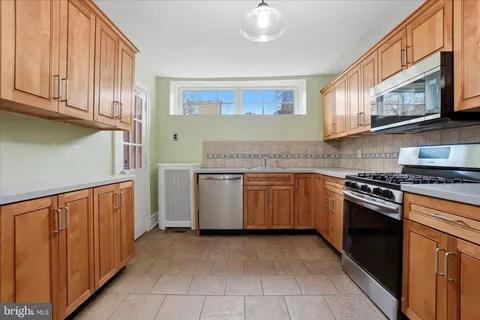 a kitchen with stainless steel appliances granite countertop a stove and a sink