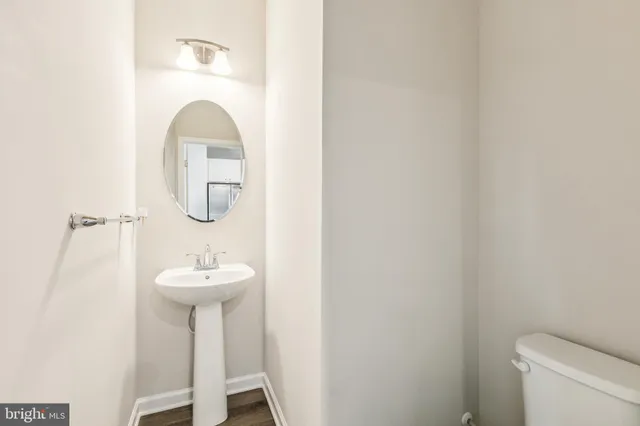 a bathroom with a sink toilet and a mirror