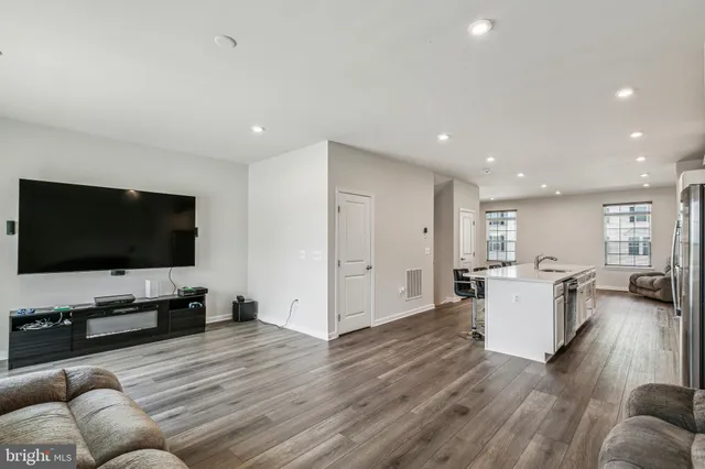 a large white kitchen with sink stove and refrigerator