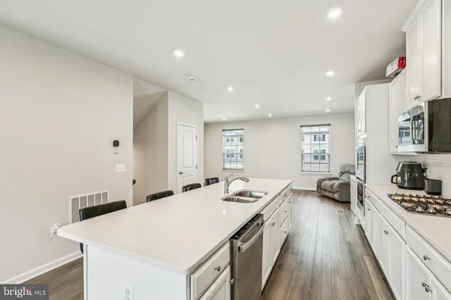 a kitchen with a sink and a stove top oven