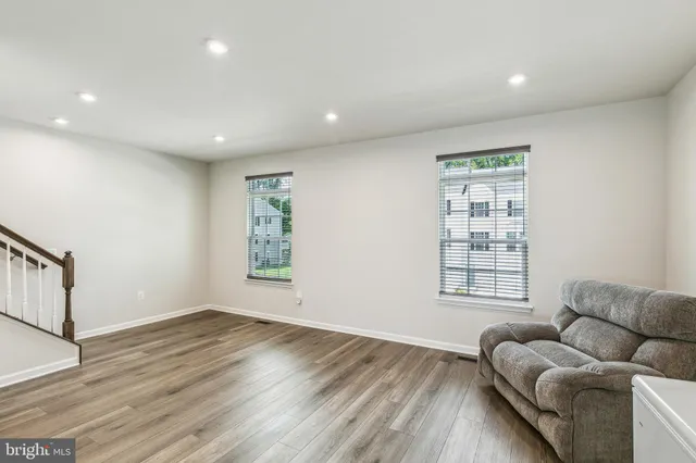 a living room with furniture and kitchen view
