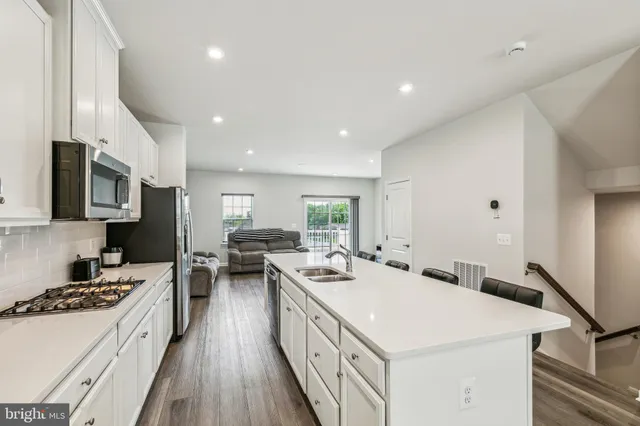 a kitchen with a sink stove and cabinets