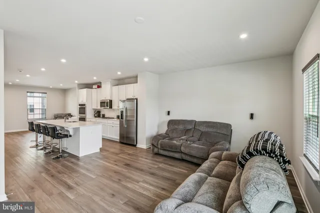 a living room with furniture and kitchen view