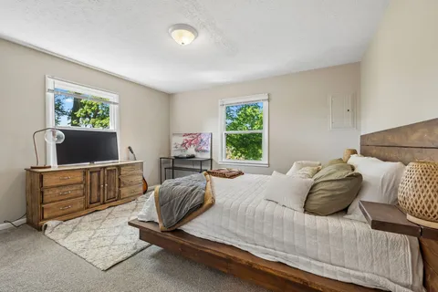 a bedroom with a bed and flat screen tv