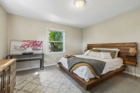 a bedroom with a bed and window