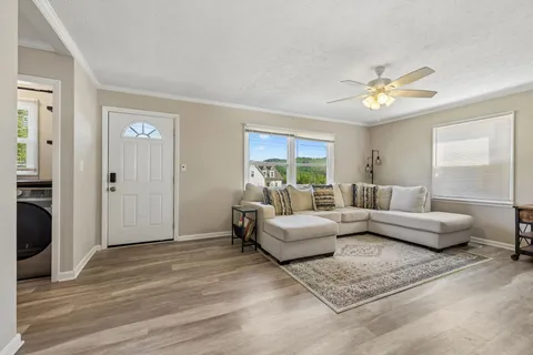 a living room with furniture and a chandelier