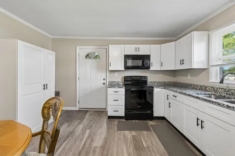 a kitchen with stainless steel appliances granite countertop a stove and a refrigerator