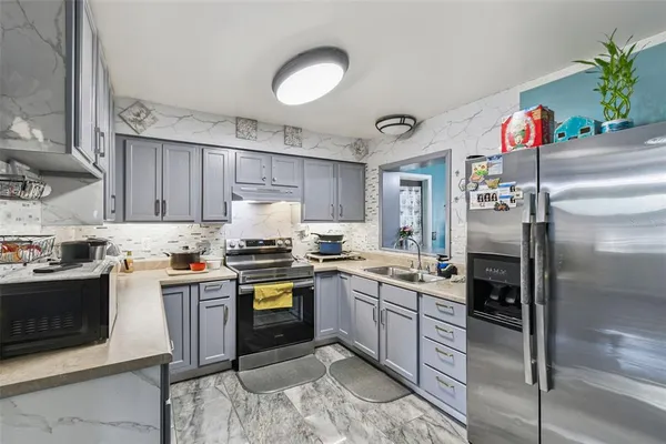 a bedroom with a bed a window and painting on the wall